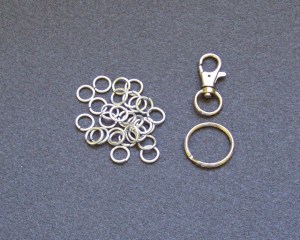 The raw materials - 29 jump rings, a split o-ring, and a trigger snap.